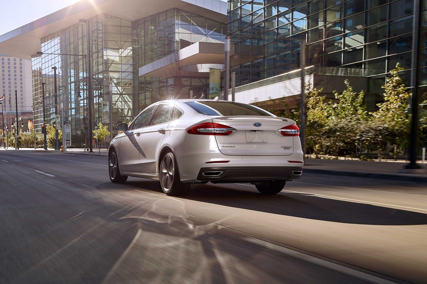 2019 Ford Fusion White Rear Exterior Driving.jpeg